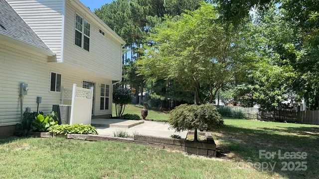 a backyard of a house with table and chairs