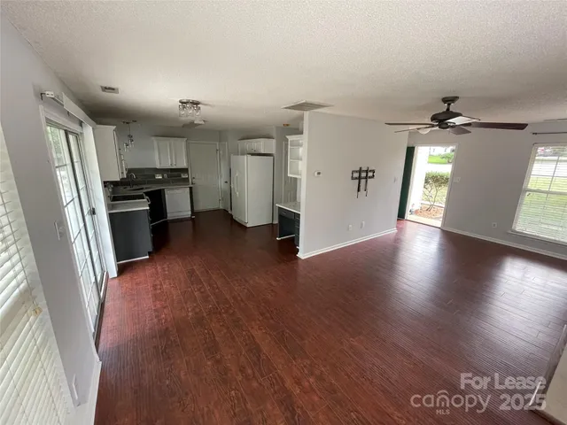 a kitchen with a refrigerator and a stove top oven