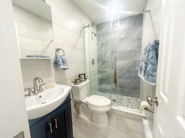 a bathroom with a sink toilet and shower