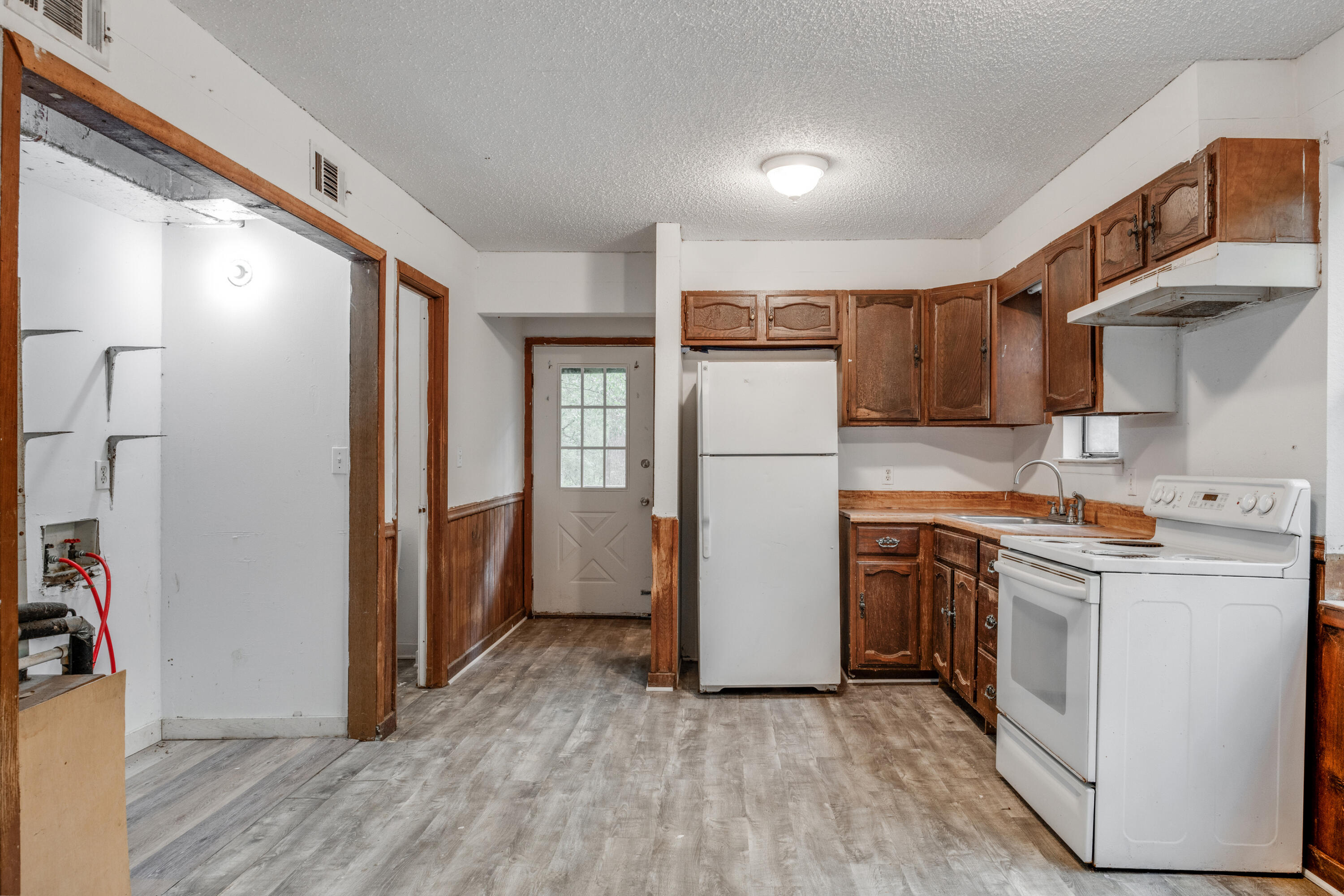 4157 Sundance Way Holt, FL 32564 - Photo 13 of 30 a kitchen with a refrigerator a stove and wooden floor
