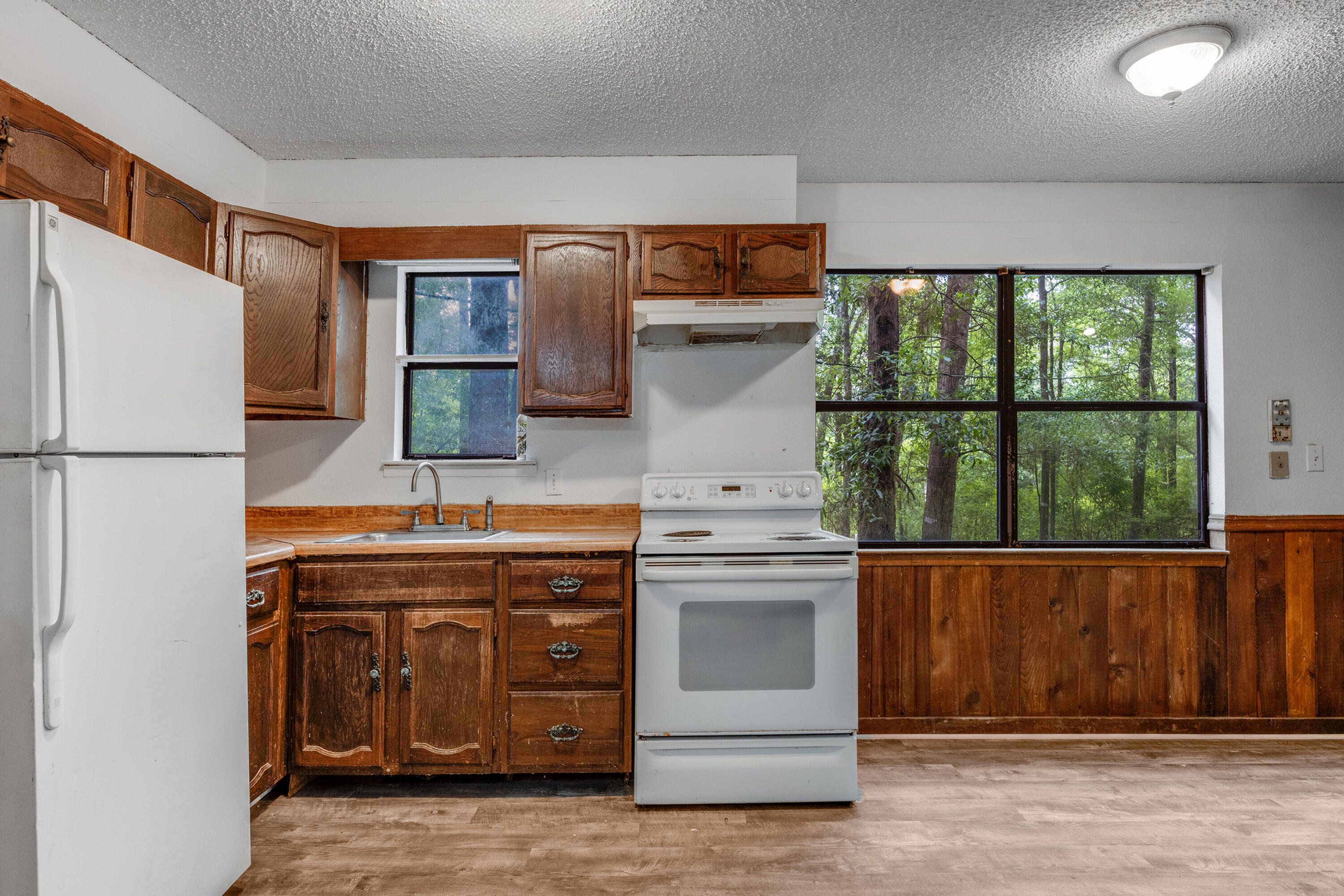 4157 Sundance Way Holt, FL 32564 - Photo 14 of 30 a kitchen with a refrigerator and a sink