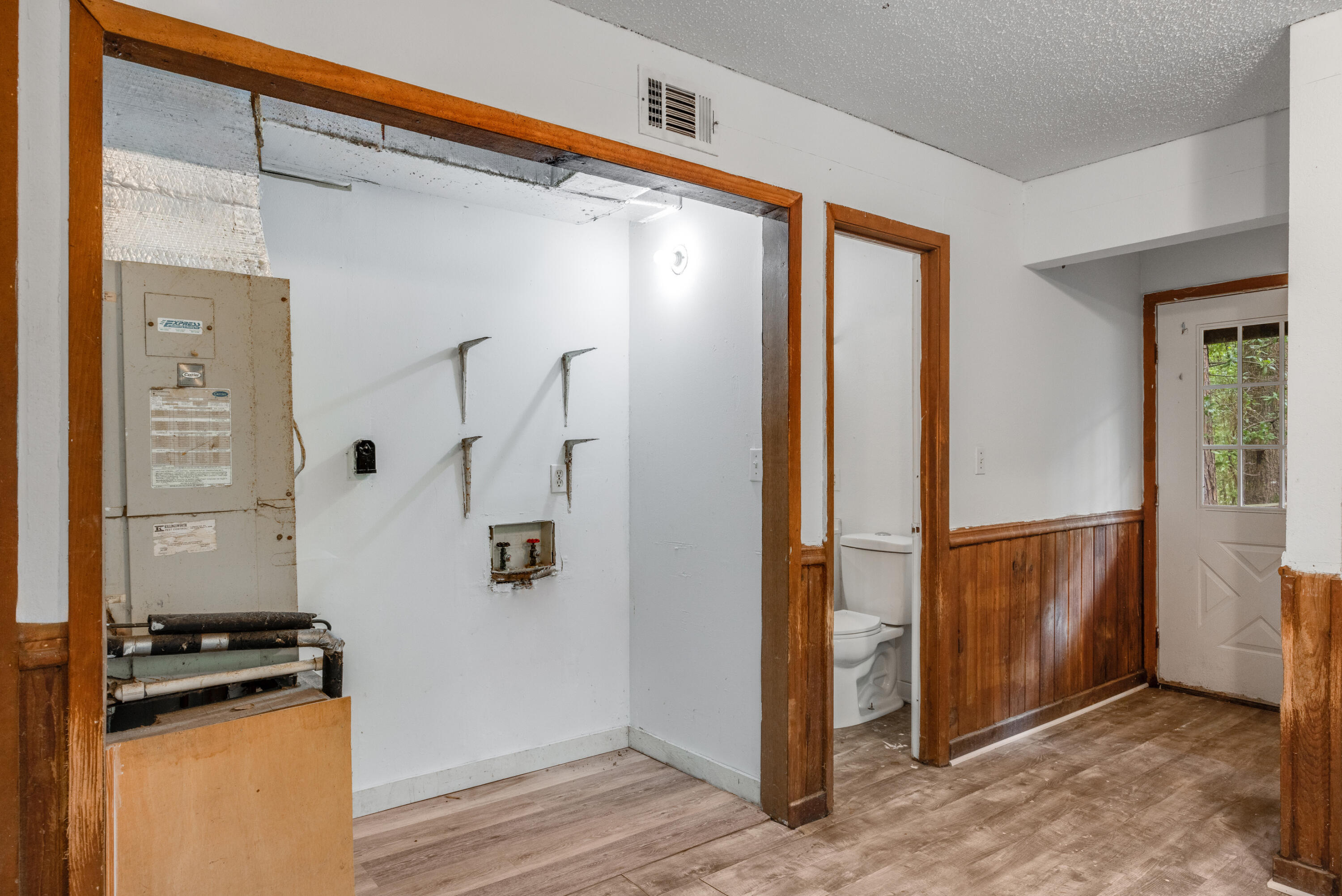 4157 Sundance Way Holt, FL 32564 - Photo 16 of 30 a view of a kitchen with an entryway and wooden floor