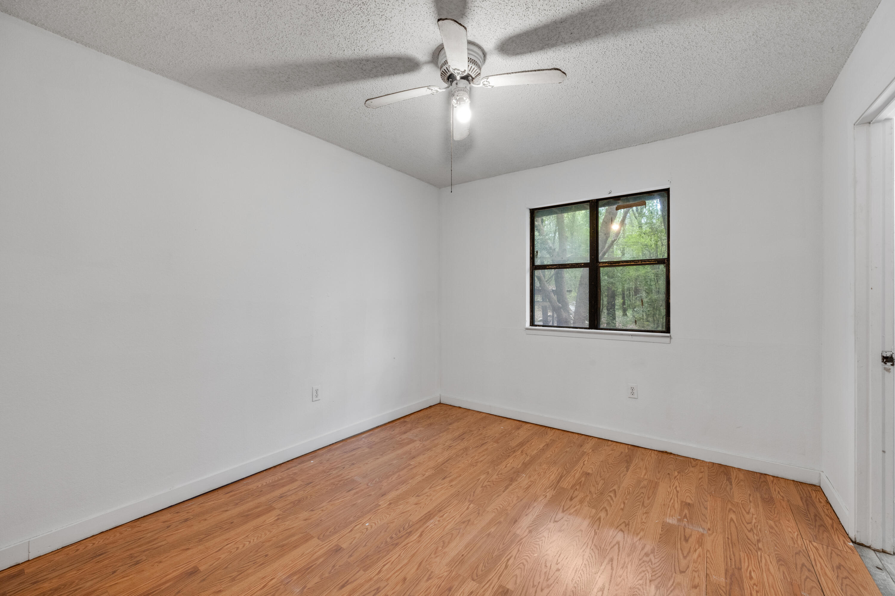 4157 Sundance Way Holt, FL 32564 - Photo 18 of 30 an empty room with a window and a ceiling fan