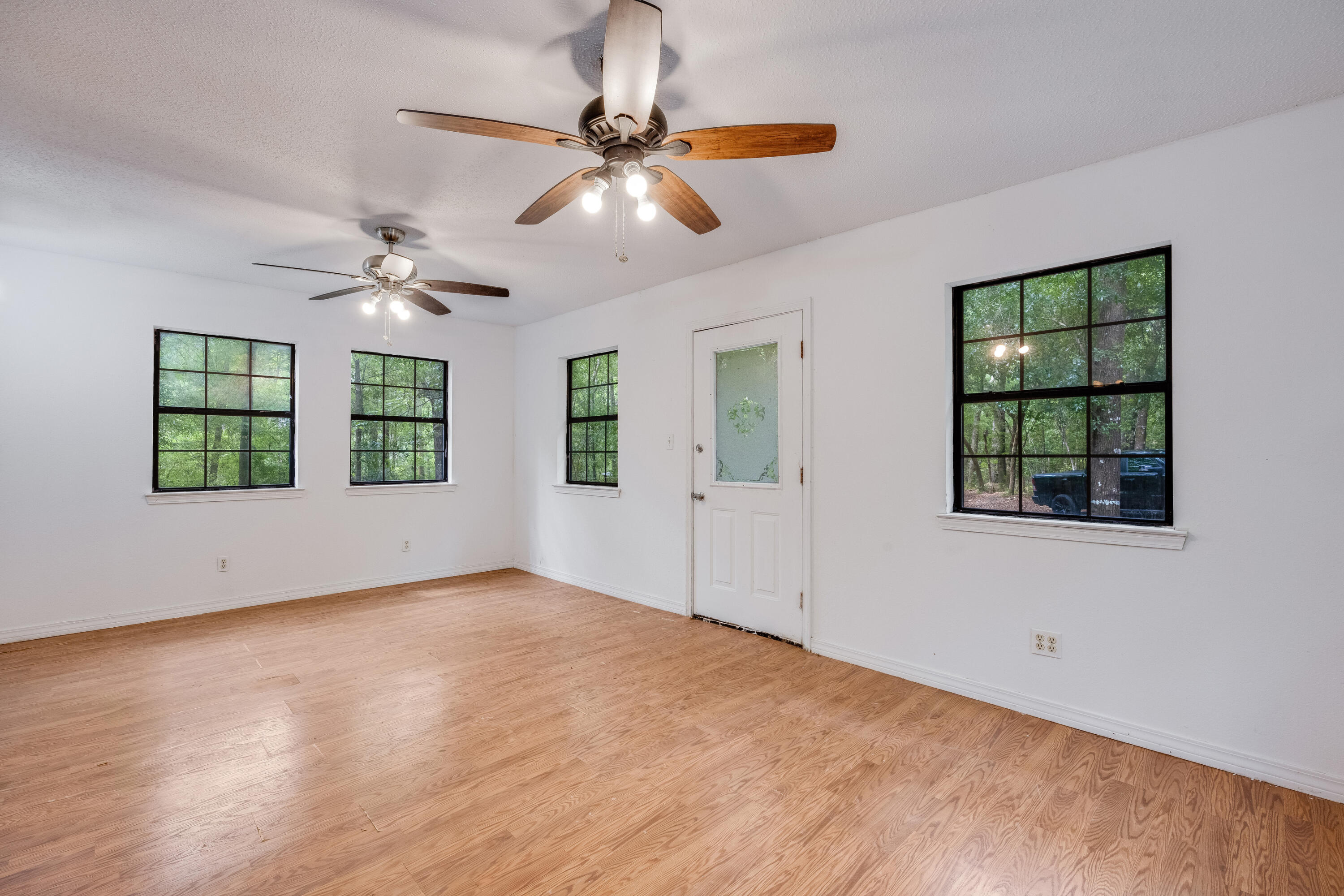 4157 Sundance Way Holt, FL 32564 - Photo 2 of 30 an empty room with windows and ceiling fan