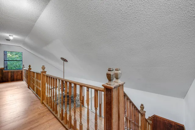 a view of an empty room with closet and a chandelier fan