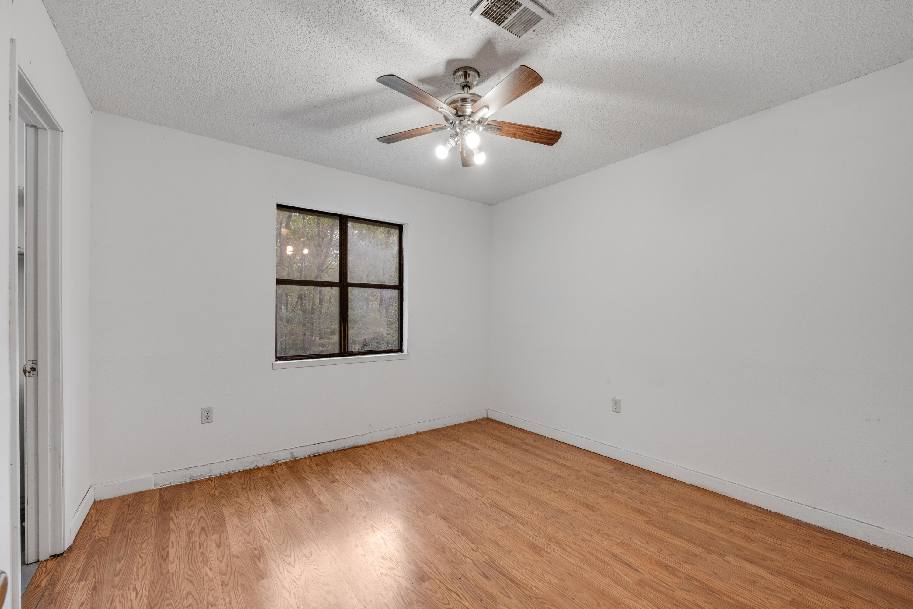 4157 Sundance Way Holt, FL 32564 - Photo 23 of 30 wooden floor in an empty room with a window