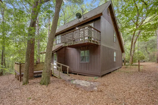 a view of outdoor space with deck and wooden fence