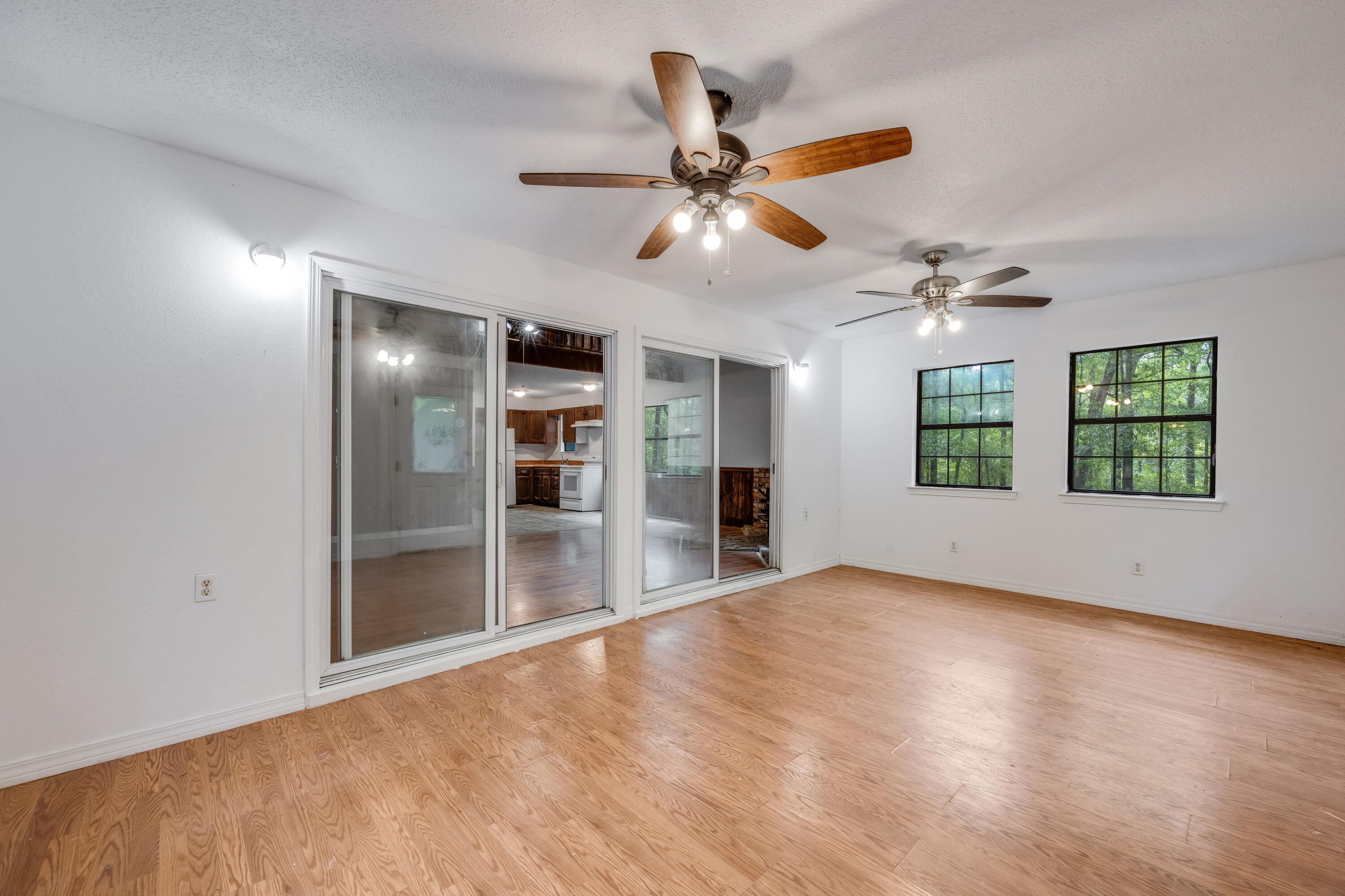 4157 Sundance Way Holt, FL 32564 - Photo 5 of 30 wooden floor in an empty room with a window