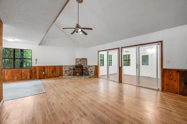 a view of a livingroom with hardwood floor and a ceiling fan