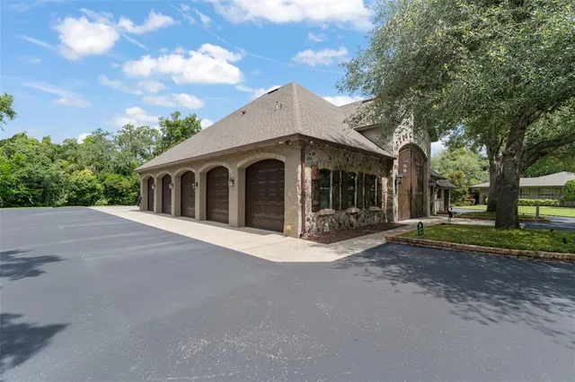 a large swimming pool that has lawn chairs in front of a house