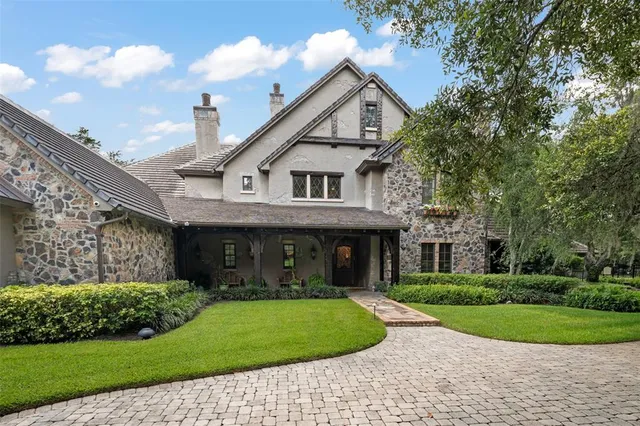 a large kitchen with kitchen island white cabinets and stainless steel appliances
