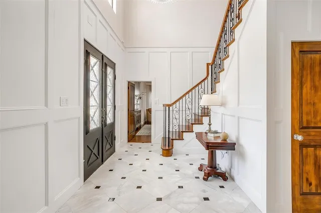 a view of a dining room with furniture a chandelier and wooden floor