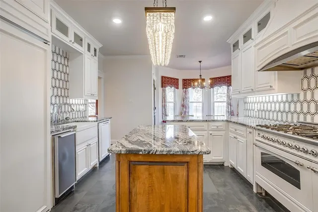 a kitchen with appliances a sink and cabinets