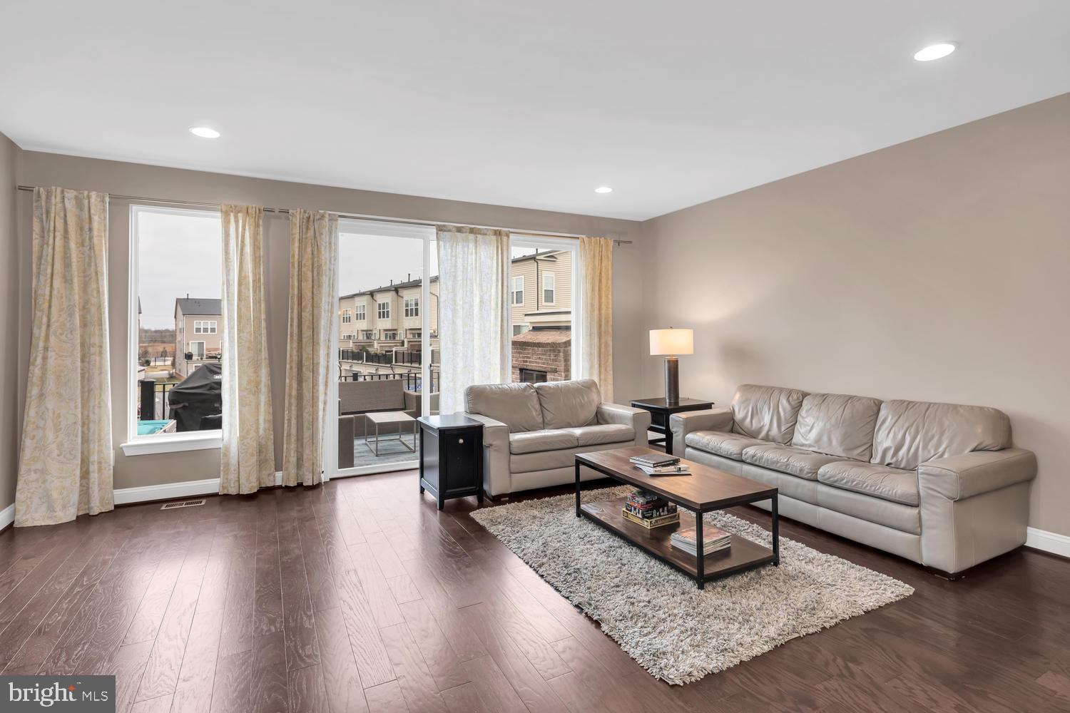 42247 Riggins Ridge Terrace Brambleton, VA 20148 - Photo 7 of 30 Living room area with floor to ceiling windows