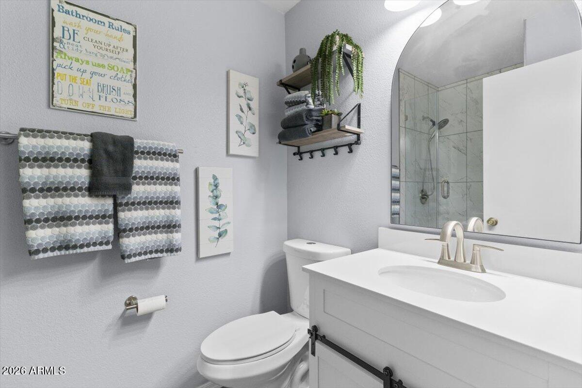 7905 West Thunderbird Road, Unit 285 Peoria, AZ 85381 - Photo 14 of 27 a bathroom with a sink a toilet and a mirror