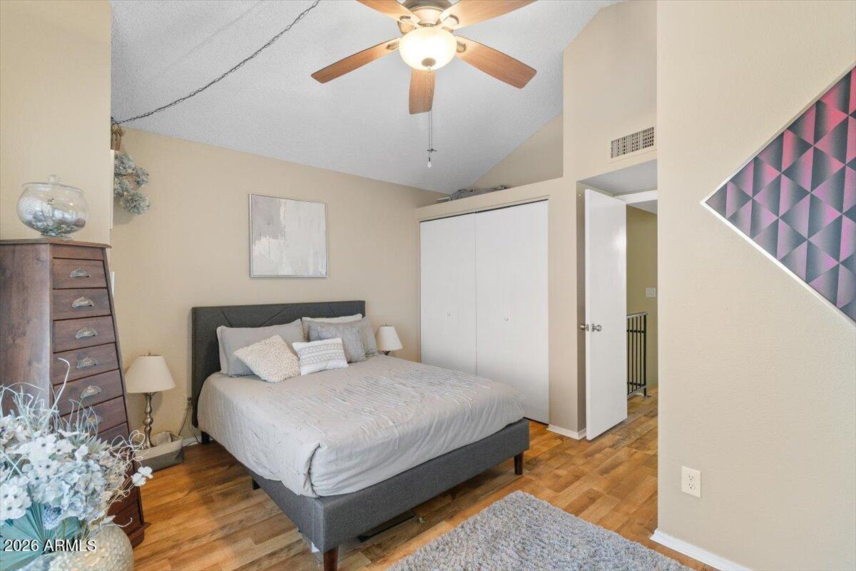 7905 West Thunderbird Road, Unit 285 Peoria, AZ 85381 - Photo 16 of 27 a bedroom with a bed and a chandelier