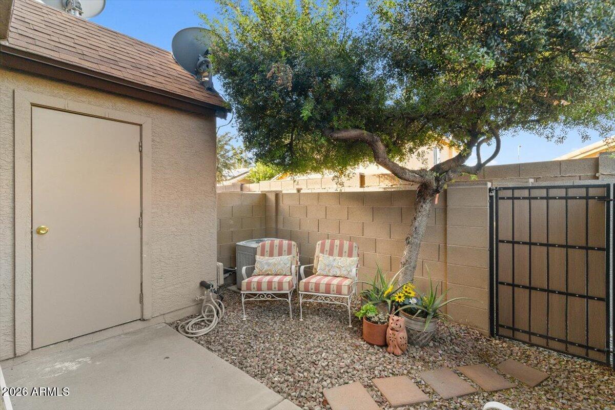 7905 West Thunderbird Road, Unit 285 Peoria, AZ 85381 - Photo 18 of 27 a backyard of a house with table and chairs