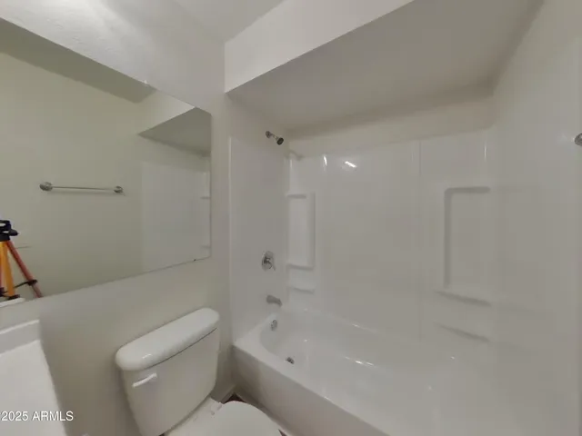 a bathroom with a bathtub and a toilet