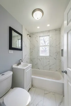 a bathroom with a toilet a sink and bathtub