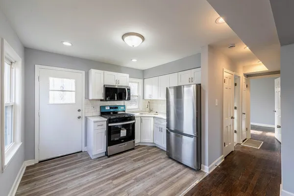 a kitchen with stainless steel appliances granite countertop a refrigerator stove and microwave