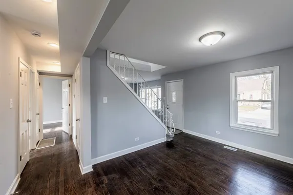 a view of a hallway view with wooden floor and staircase