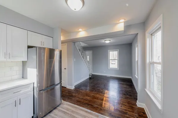 a kitchen with stainless steel appliances granite countertop a refrigerator and a stove top oven