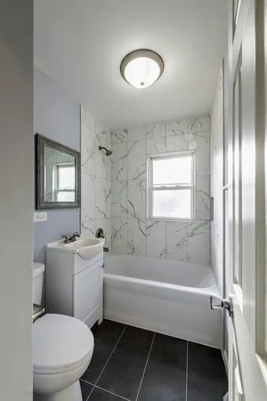 a bathroom with a sink toilet and shower
