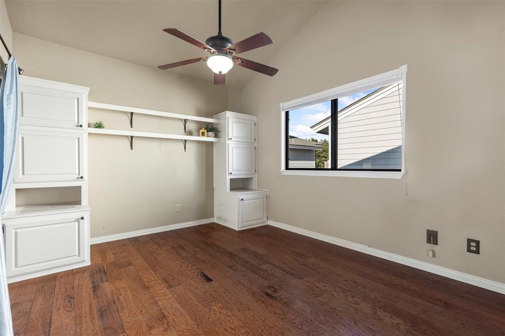 17490 Meandering Way, Unit 404 Dallas, TX 75252 - Photo 14 of 25 an empty room with wooden floor fan and windows
