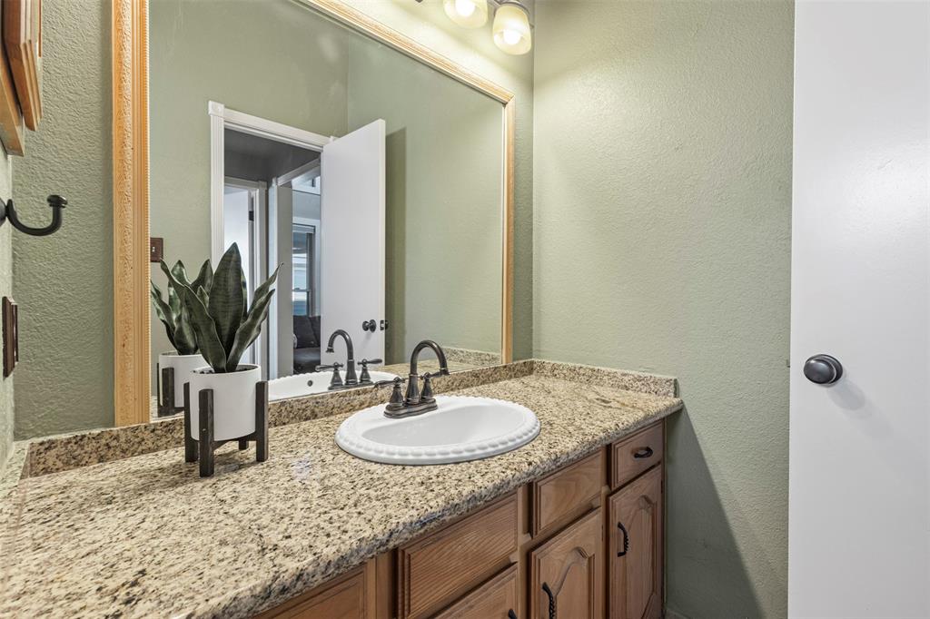 17490 Meandering Way, Unit 404 Dallas, TX 75252 - Photo 17 of 25 a bathroom with a granite countertop sink and a mirror