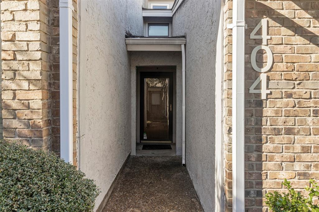 17490 Meandering Way, Unit 404 Dallas, TX 75252 - Photo 4 of 25 a view of a hallway with wooden door and stairs
