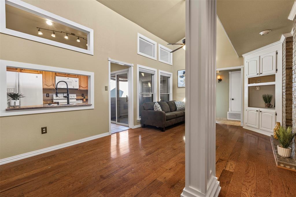 17490 Meandering Way, Unit 404 Dallas, TX 75252 - Photo 10 of 25 a living room with furniture wooden floor and a large window