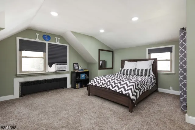 a spacious bedroom with a bed and a cabinets