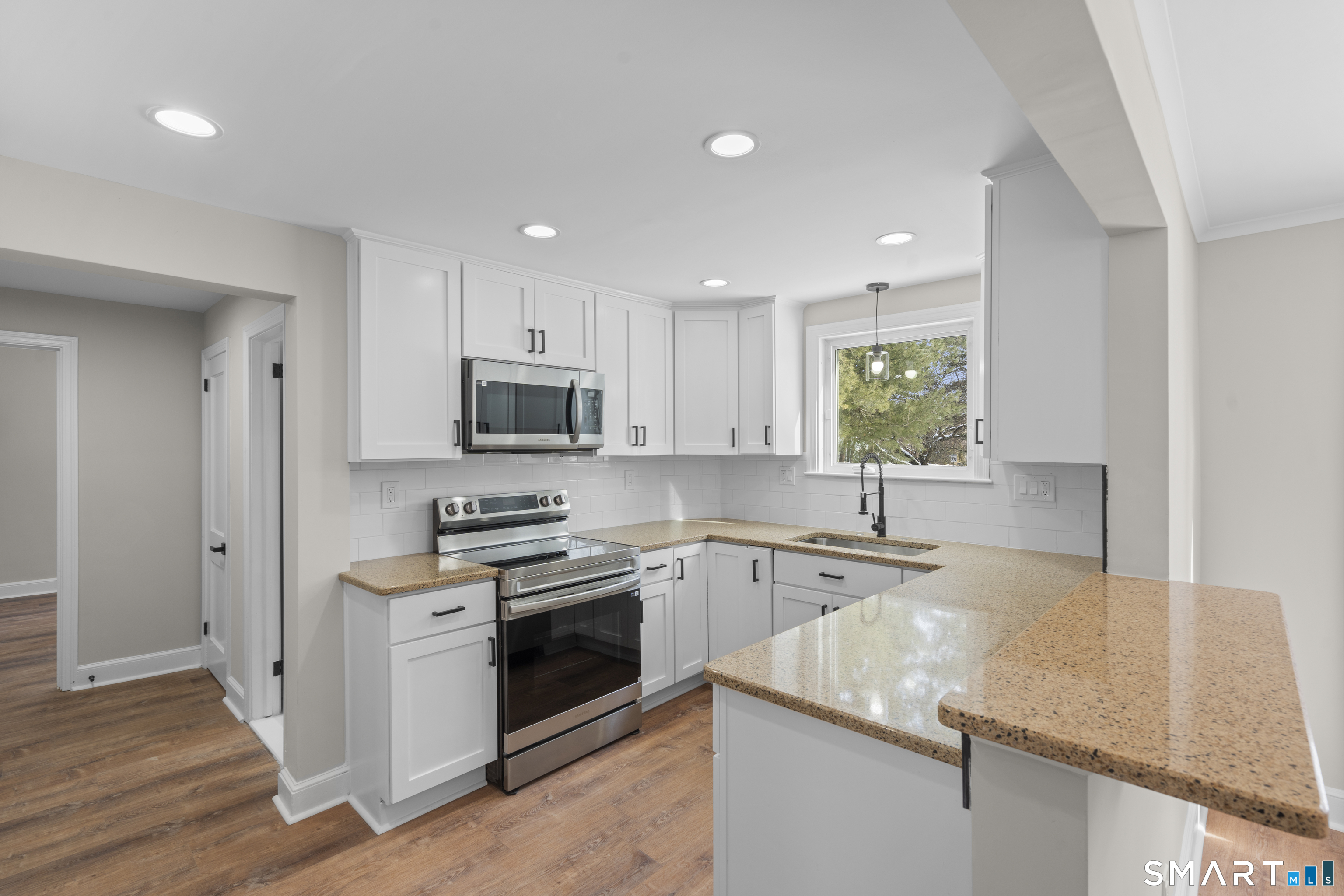 608 Kennedy Road Windsor, CT 06095 - Photo 12 of 39 a kitchen with stainless steel appliances granite countertop a sink stove and refrigerator