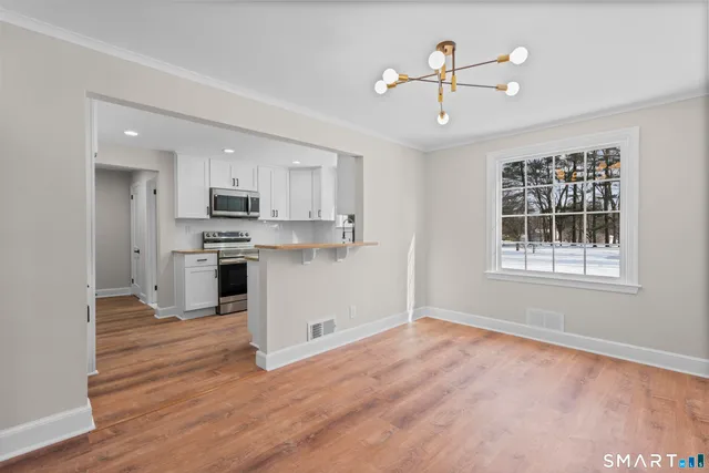 a view of kitchen with sink microwave and refrigerator