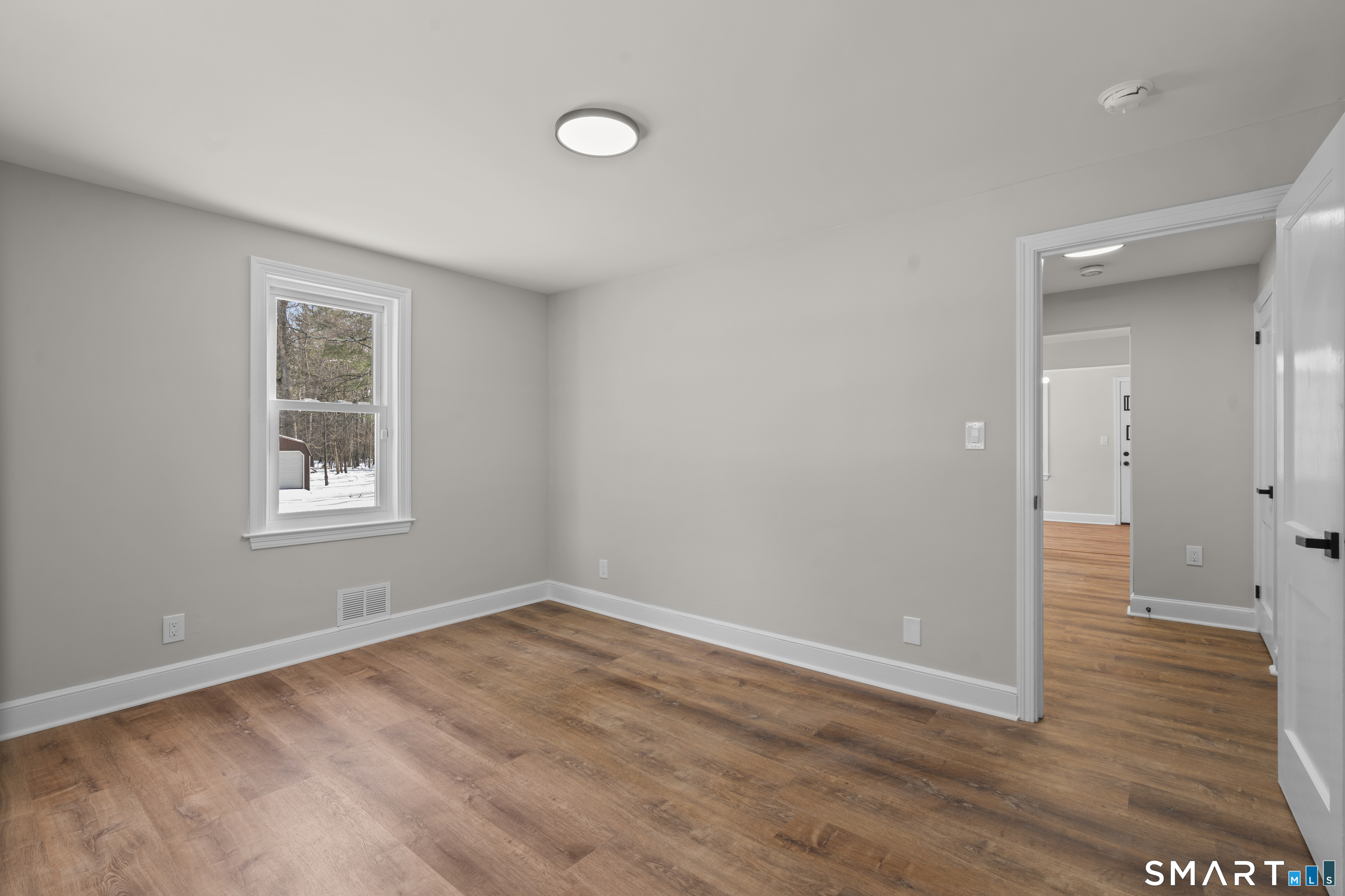 608 Kennedy Road Windsor, CT 06095 - Photo 21 of 39 an empty room with wooden floor and windows
