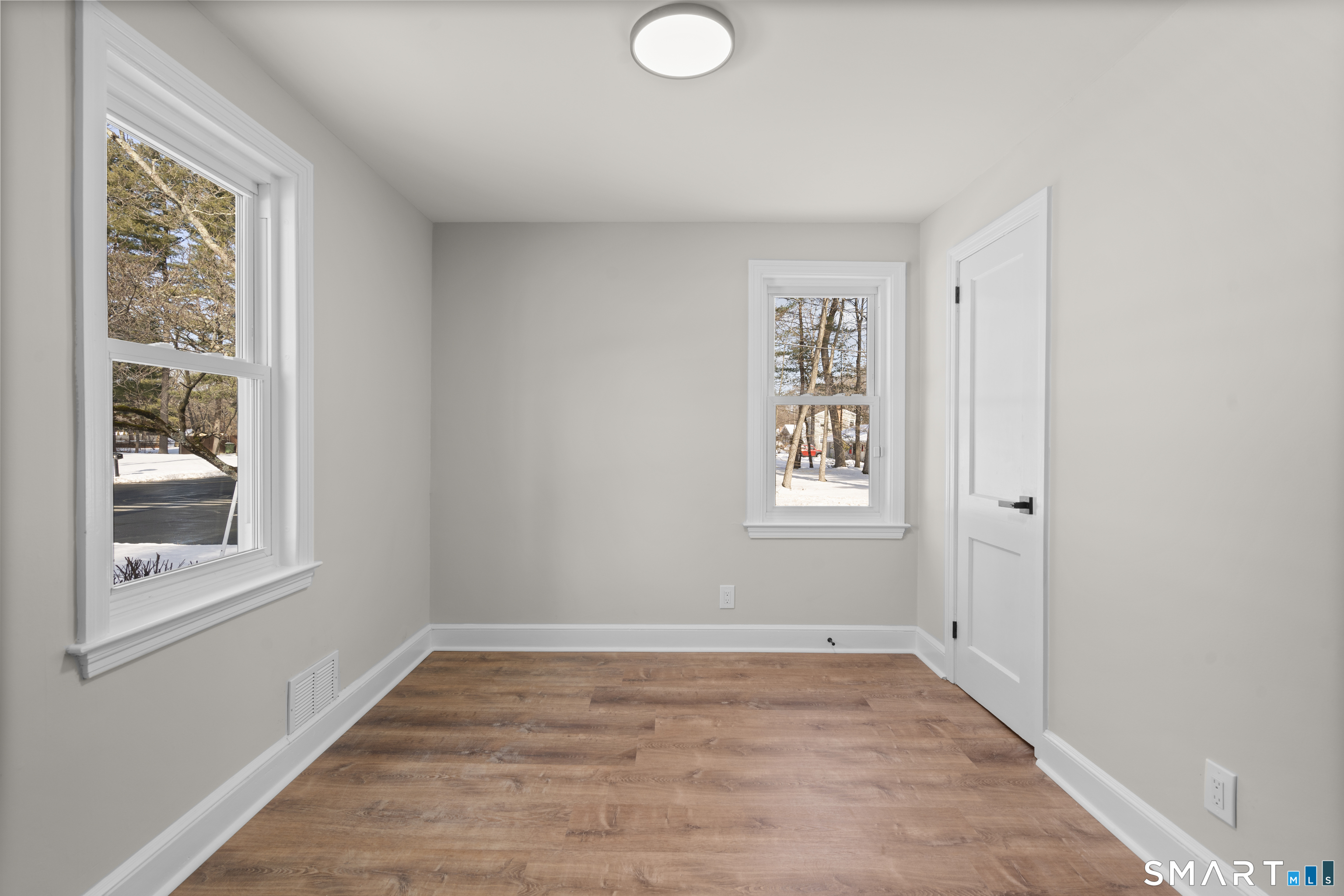 608 Kennedy Road Windsor, CT 06095 - Photo 22 of 39 a view of an empty room with wooden floor and a window