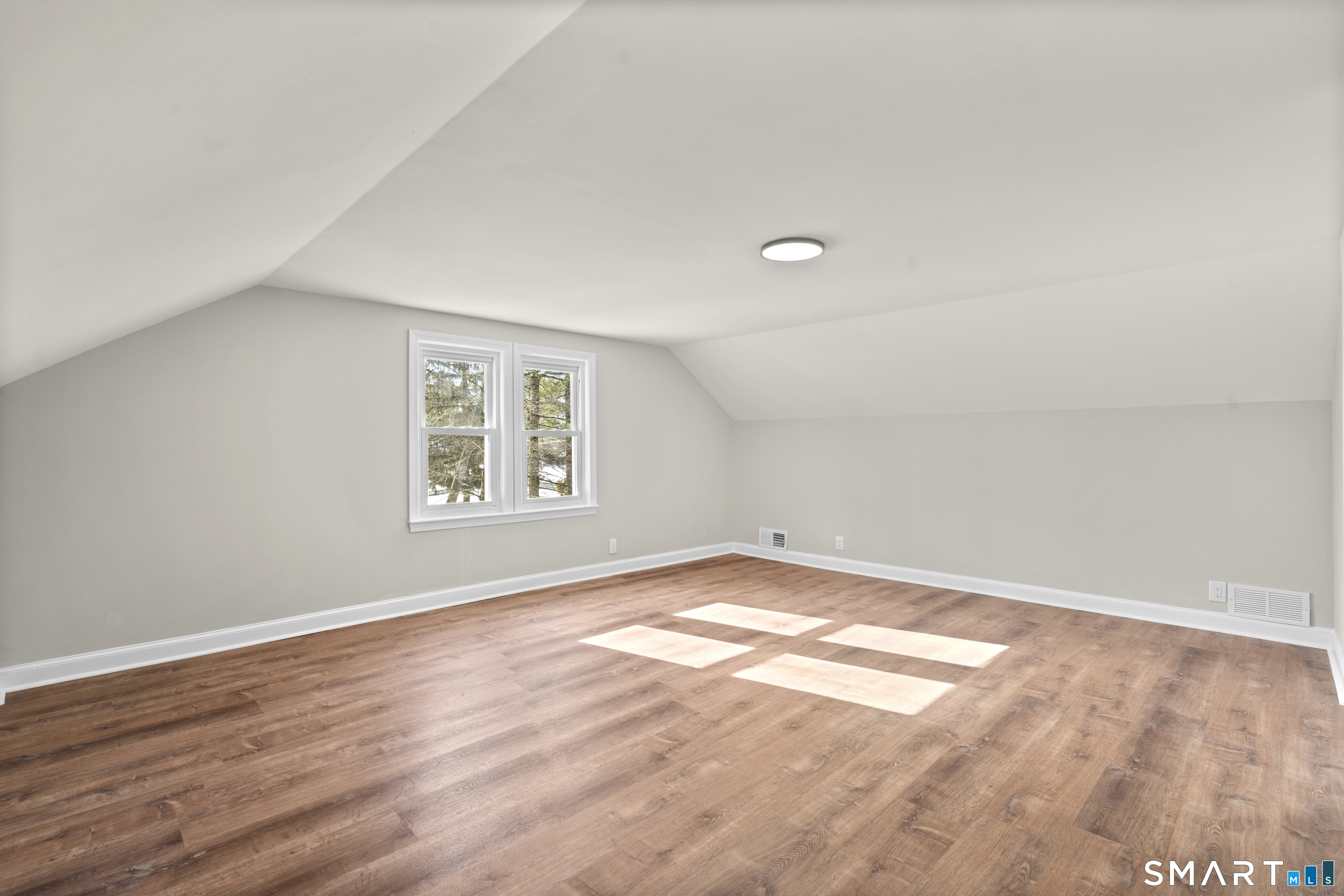 608 Kennedy Road Windsor, CT 06095 - Photo 30 of 39 an empty room with wooden floor and windows