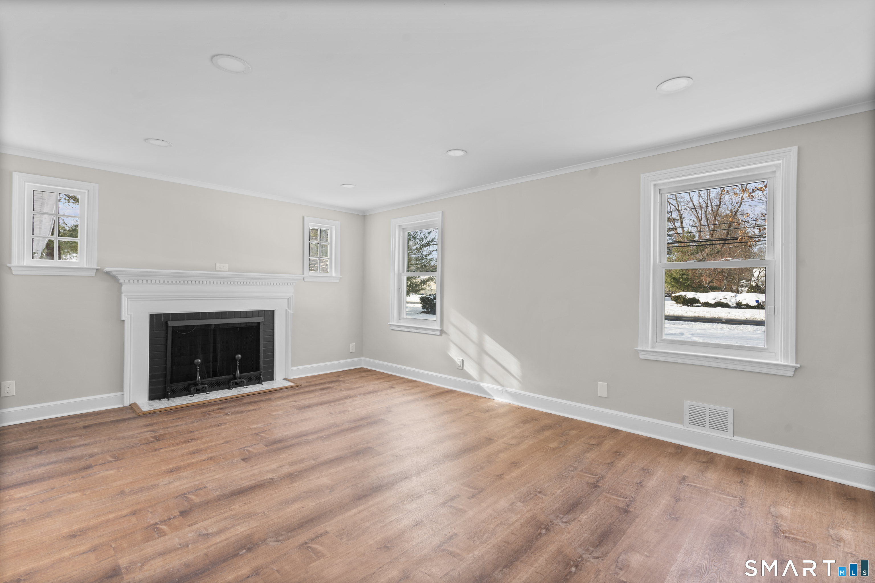 608 Kennedy Road Windsor, CT 06095 - Photo 5 of 39 a view of an empty room with wooden floor fireplace and a window