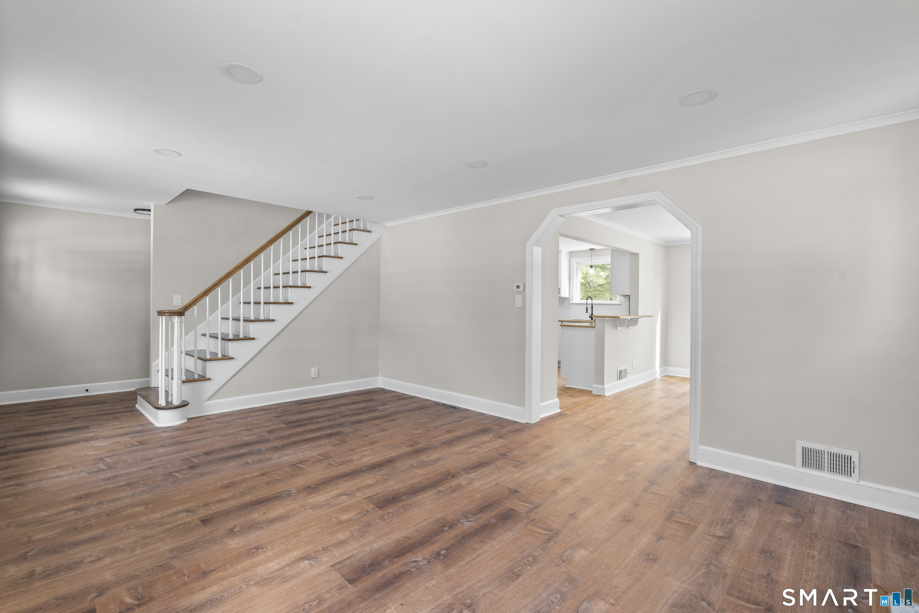 608 Kennedy Road Windsor, CT 06095 - Photo 6 of 39 a view of an empty room with wooden floor and stairs