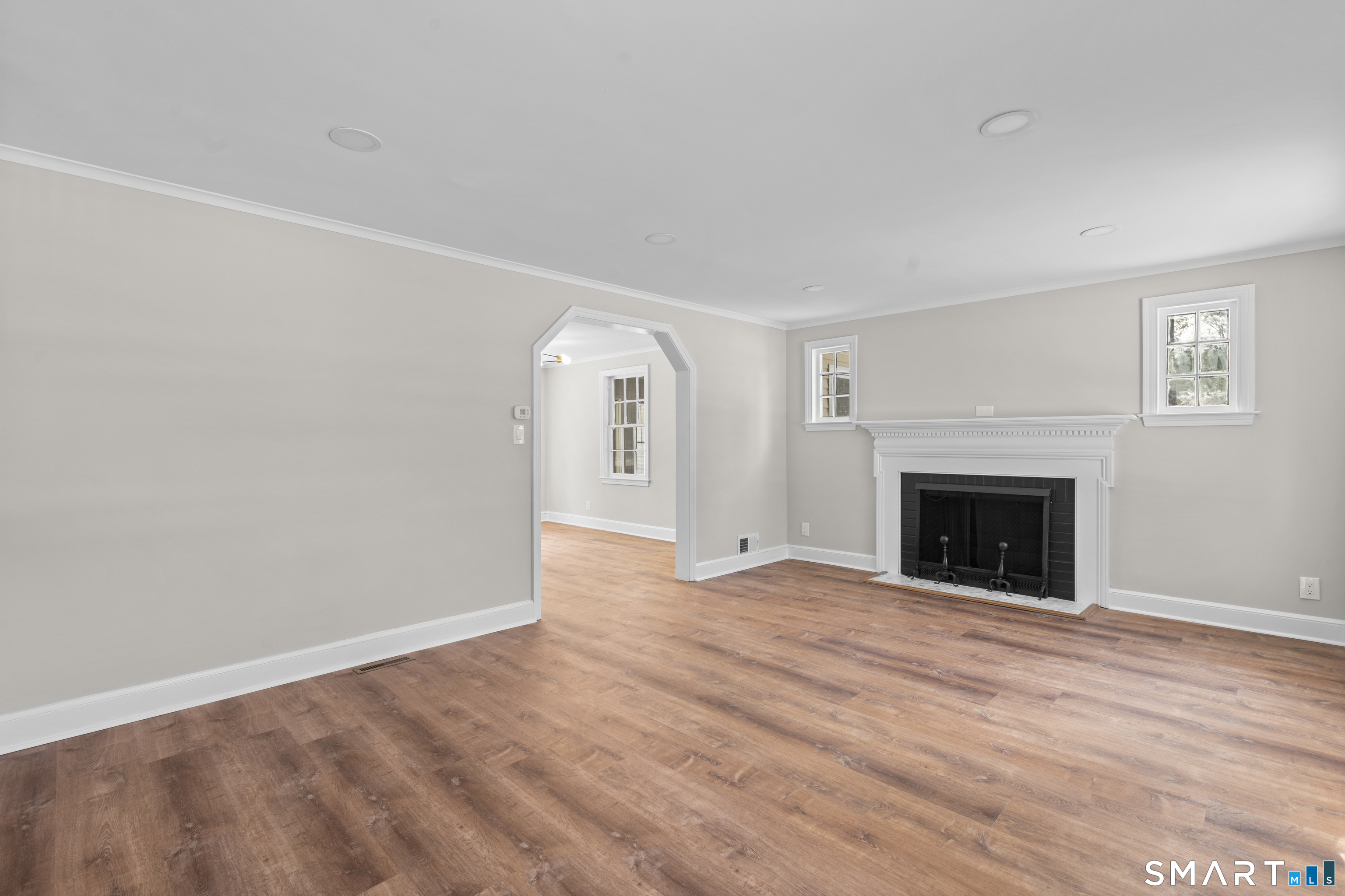 608 Kennedy Road Windsor, CT 06095 - Photo 8 of 39 a view of an empty room with wooden floor fireplace and a window