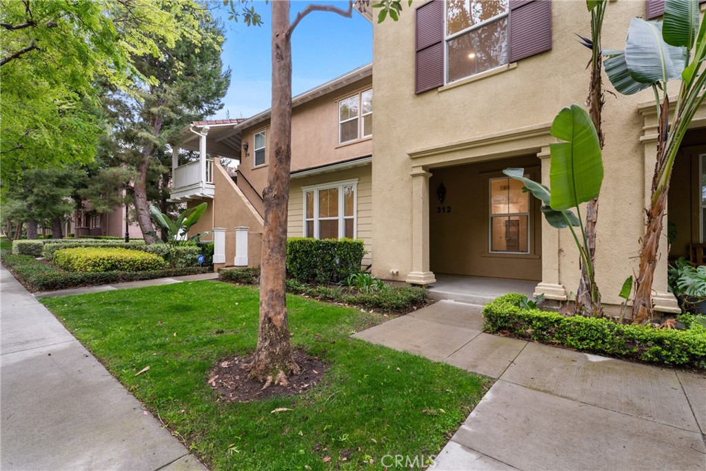 312 Quail Ridge Irvine, CA 92603 - Photo 1 of 20 a front view of a house with a yard