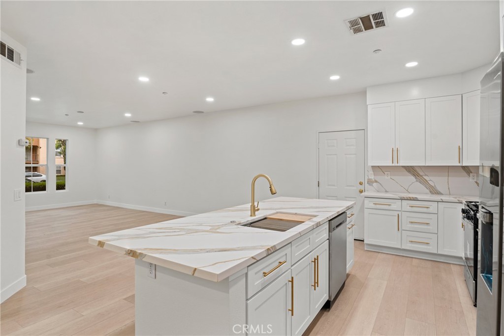 312 Quail Ridge Irvine, CA 92603 - Photo 12 of 20 a kitchen that has a sink a stove and a refrigerator