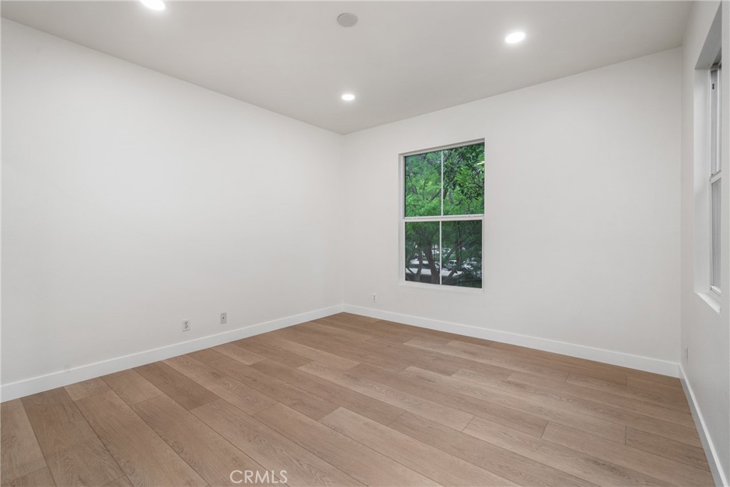 312 Quail Ridge Irvine, CA 92603 - Photo 14 of 20 an empty room with wooden floor and windows