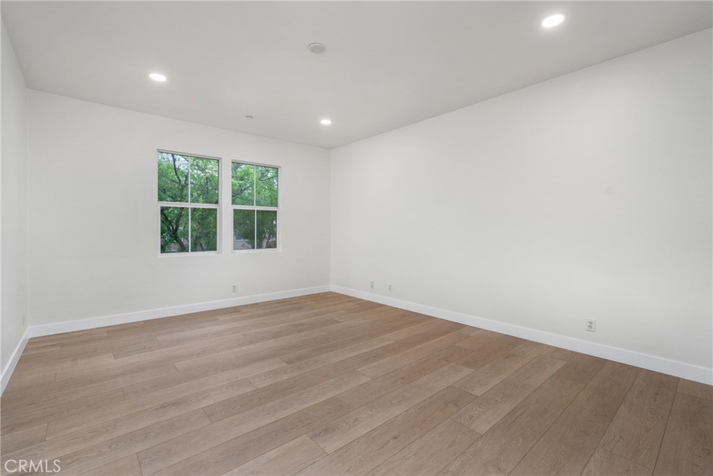 312 Quail Ridge Irvine, CA 92603 - Photo 16 of 20 an empty room with wooden floor and windows