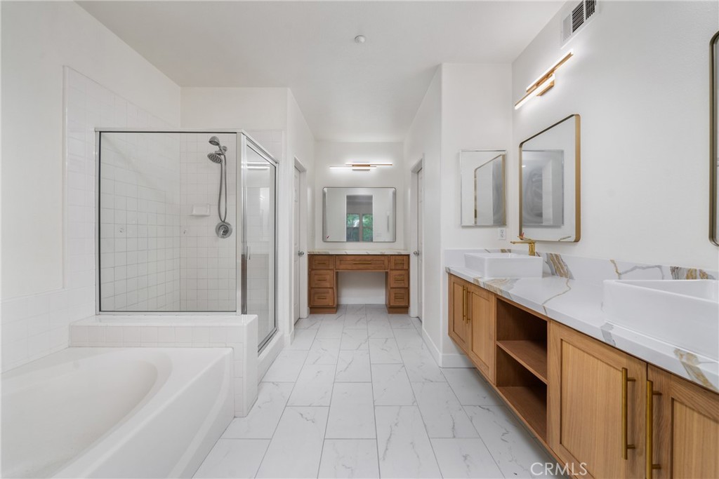 312 Quail Ridge Irvine, CA 92603 - Photo 19 of 20 a spacious bathroom with a tub double sink shower and mirror