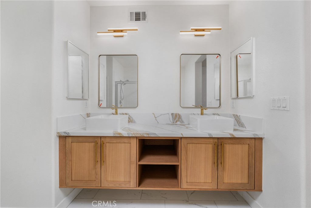 312 Quail Ridge Irvine, CA 92603 - Photo 20 of 20 a bathroom with a granite countertop sink and a mirror