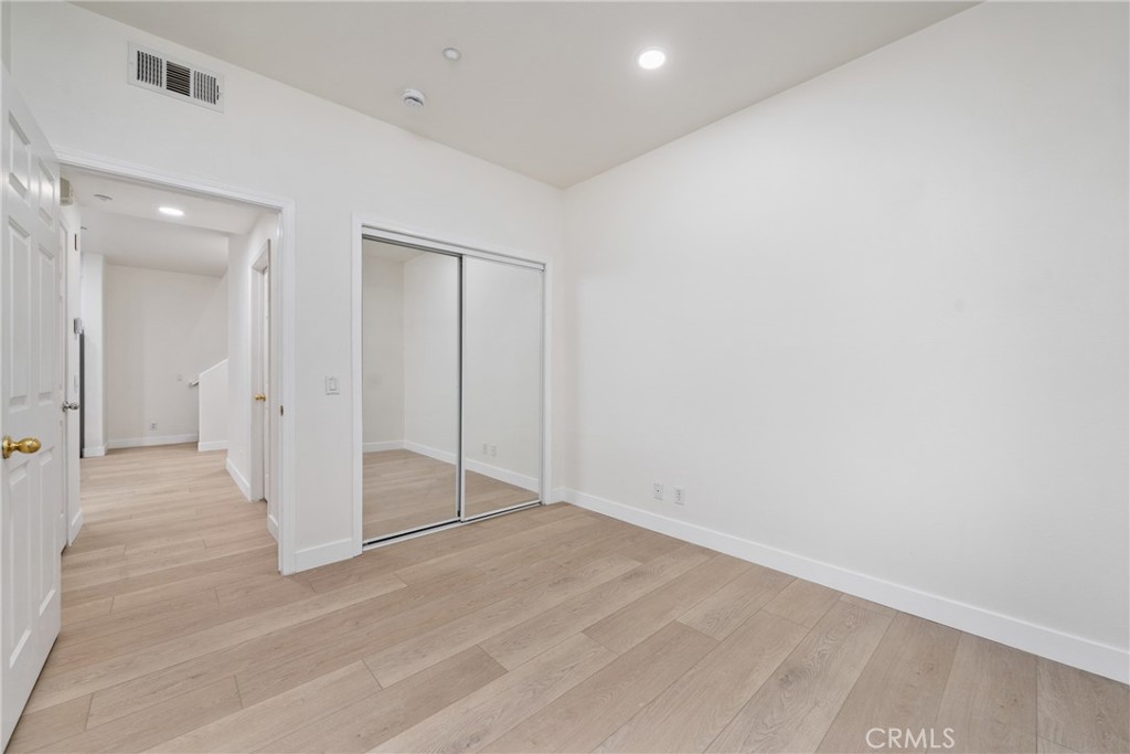 312 Quail Ridge Irvine, CA 92603 - Photo 7 of 20 an empty room with wooden floor