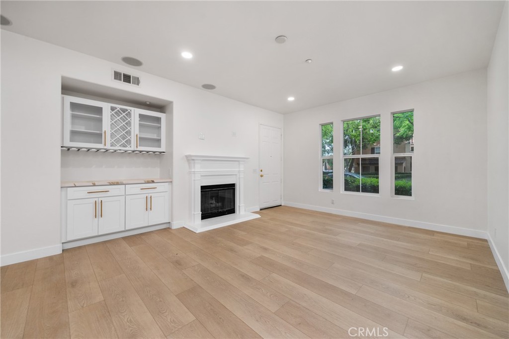 312 Quail Ridge Irvine, CA 92603 - Photo 8 of 20 a view of an empty room with a fireplace and a window