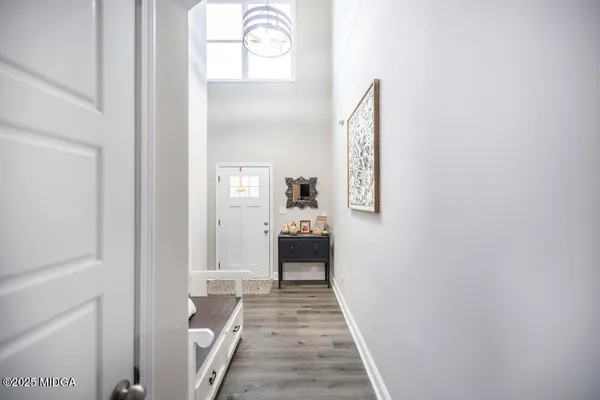 a bedroom with a bed and a flat tv screen on dresser