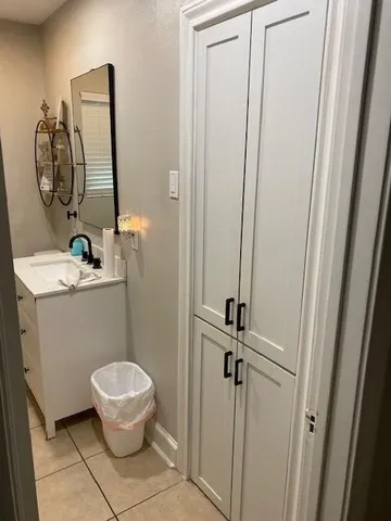 a bathroom with a toilet mirror and vanity